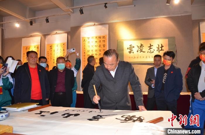 圖為“鐵軍老戰(zhàn)士”、著名書法家、解放軍報(bào)原副總編輯連俊義少將現(xiàn)場揮毫?！☆佇玛?攝 攝