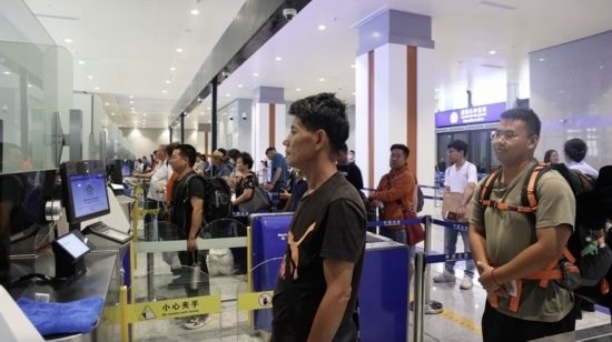 6月13日，乘坐中老鐵路國(guó)際旅客列車的旅客在磨憨邊檢大廳排隊(duì)候檢。李揚(yáng) 攝