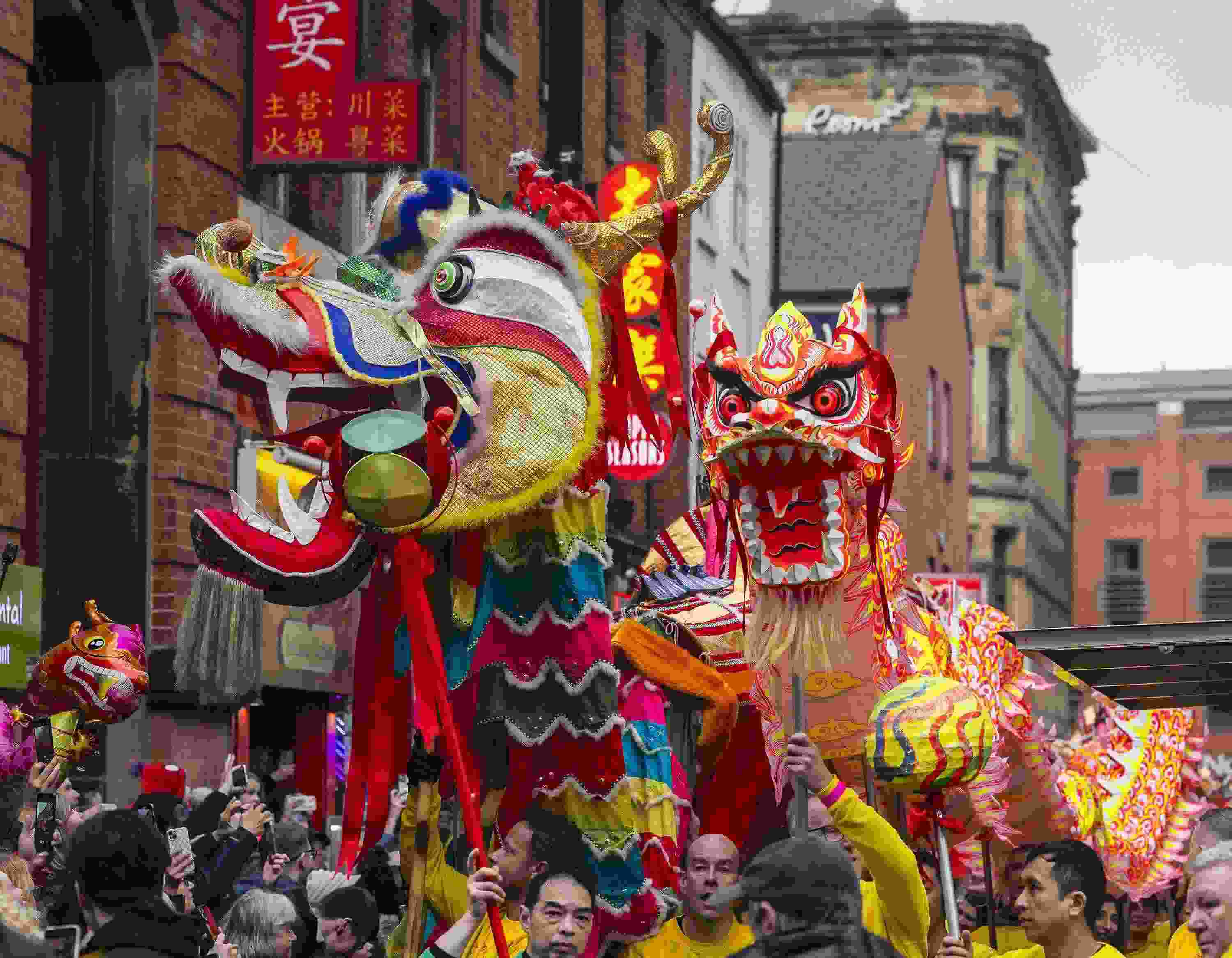 △ 當(dāng)?shù)貢r(shí)間2024年2月11日，英國(guó)曼徹斯特，表演者進(jìn)入中國(guó)城，參加中國(guó)農(nóng)歷龍年春節(jié)的慶祝活動(dòng)。