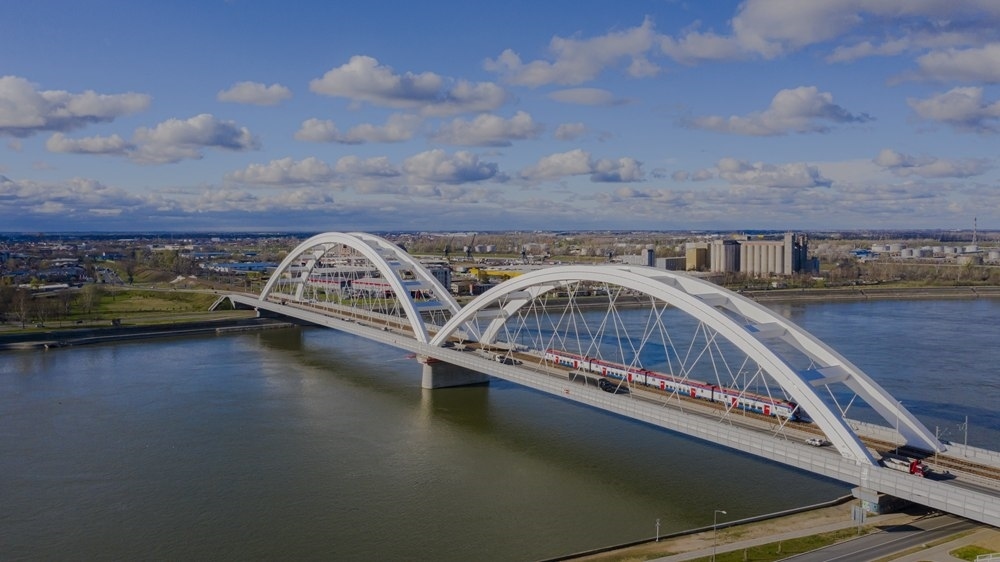 2024年3月12日，一列火車運(yùn)行在匈塞鐵路塞爾維亞境內(nèi)貝諾段諾維薩德多瑙河大橋上（無人機(jī)照片）。新華社發(fā)（任衛(wèi)云攝）