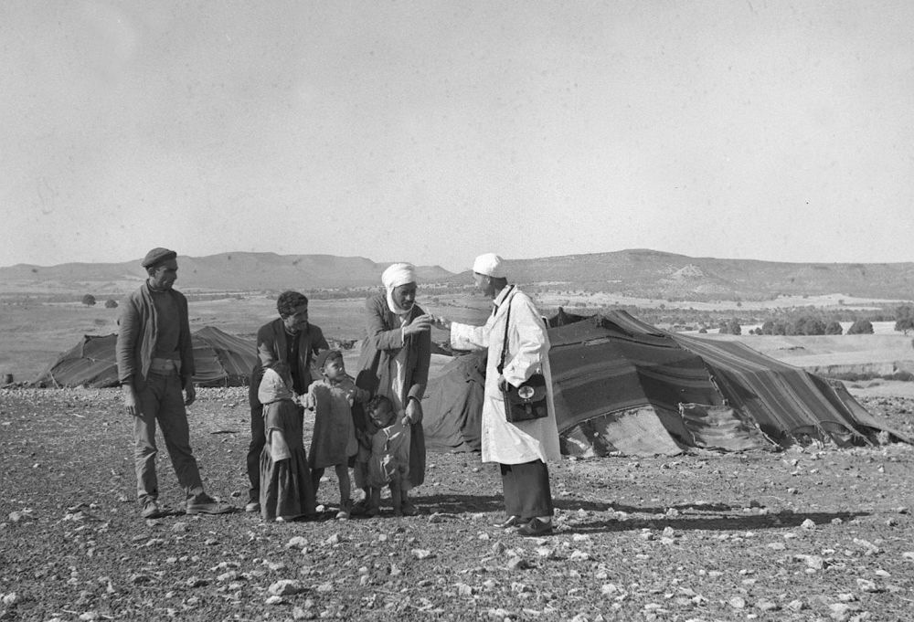 1965年，一名中國援阿爾及利亞醫(yī)療隊醫(yī)生（右一）在阿爾及利亞賽伊達省為牧民診治。