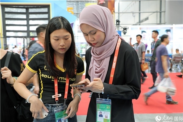 東博會(huì)現(xiàn)場(chǎng)，馬來(lái)西亞展商在同中方工作人員交談。人民網(wǎng)記者 趙益普攝
