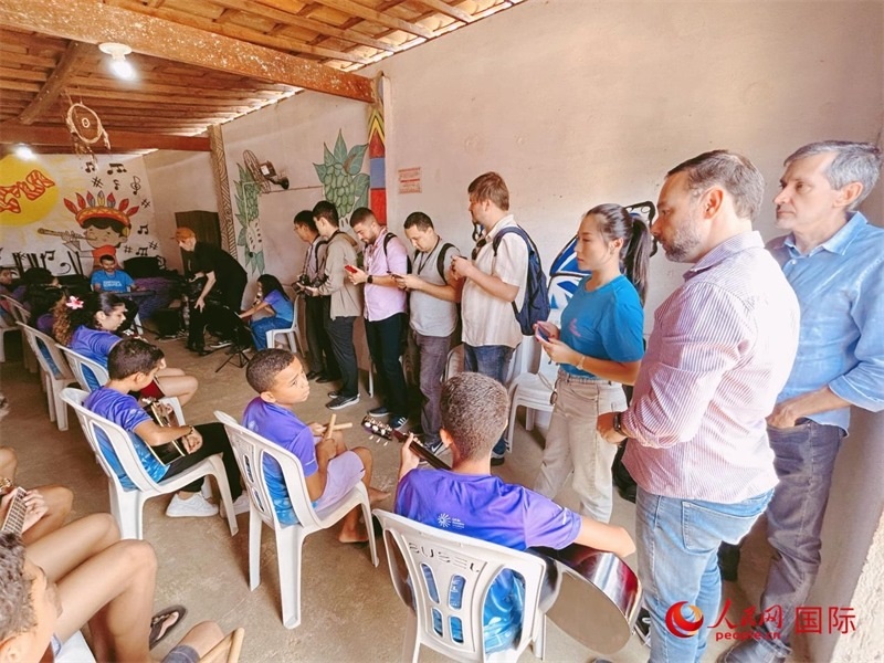  受益于中國企業(yè)的“青少年成長”項(xiàng)目，700多名當(dāng)?shù)厍嗌倌甑囊魳泛妥闱驂粝氩迳狭顺岚?。圖為聯(lián)合采訪團(tuán)正在采訪參加音樂培訓(xùn)的孩子們。 人民網(wǎng)記者 陳一鳴攝