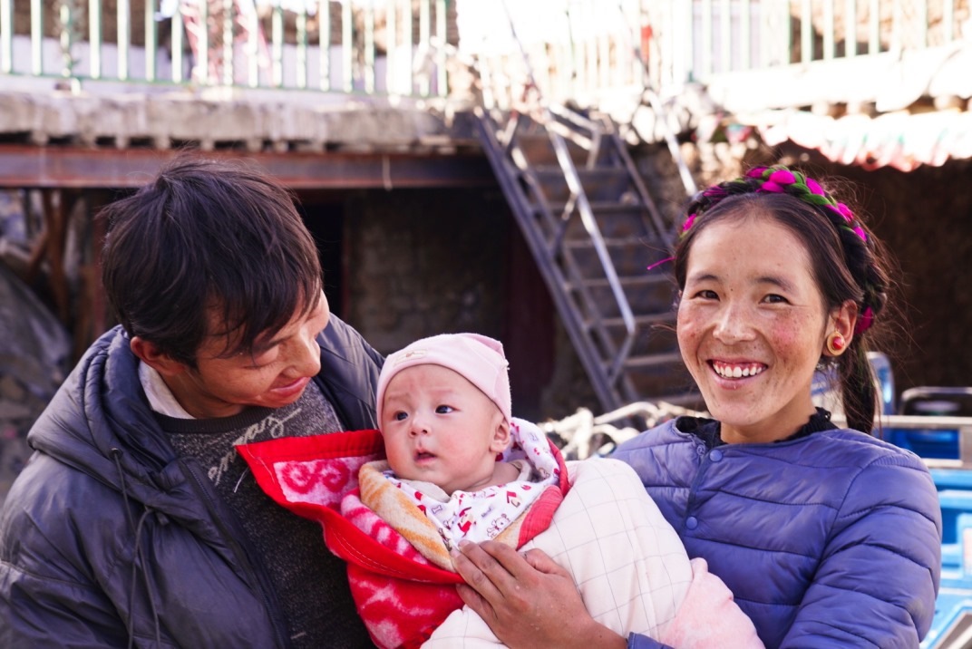 1月11日，在西藏日喀則市人民醫(yī)院，受災(zāi)群眾抱著自己在地震中受傷的孩子康復(fù)出院。人民日?qǐng)?bào)記者徐馭堯攝
