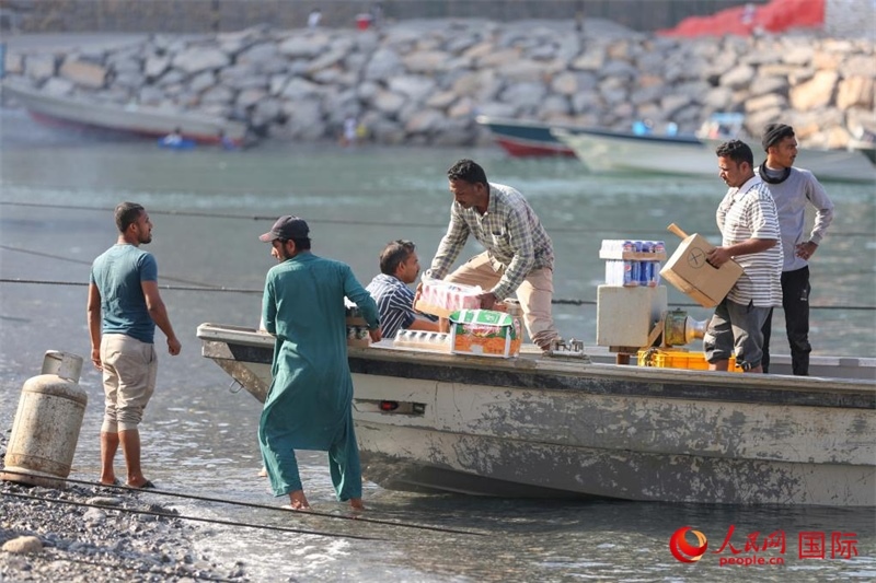 當(dāng)?shù)厝藗冊谶\(yùn)送生活物資。人民網(wǎng) 塔里克·易卜拉欣攝